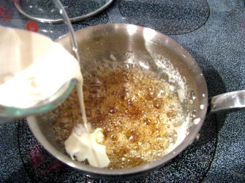 adding cream for caramel sauce