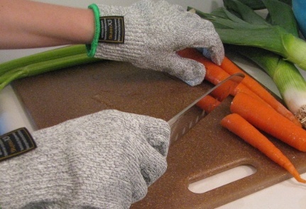 cutting carrots with gloves